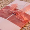 Folded weddding invitation with detailed paper and ribbon